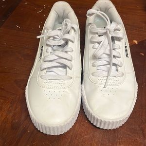 Woman’s white Puma tennis shoes
